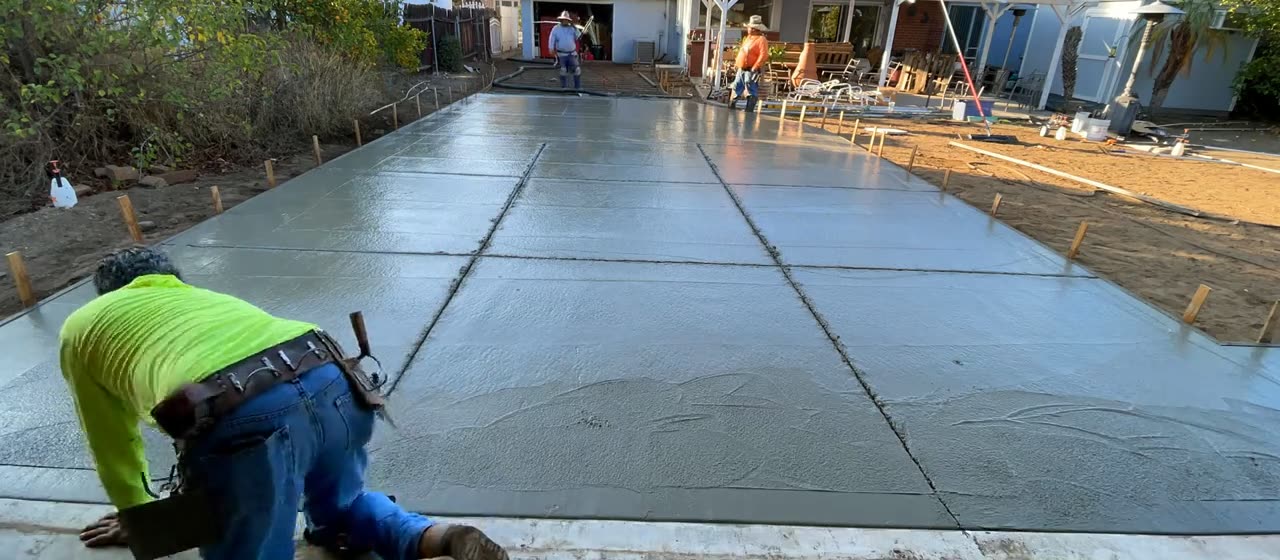 Concrete being floated and edged