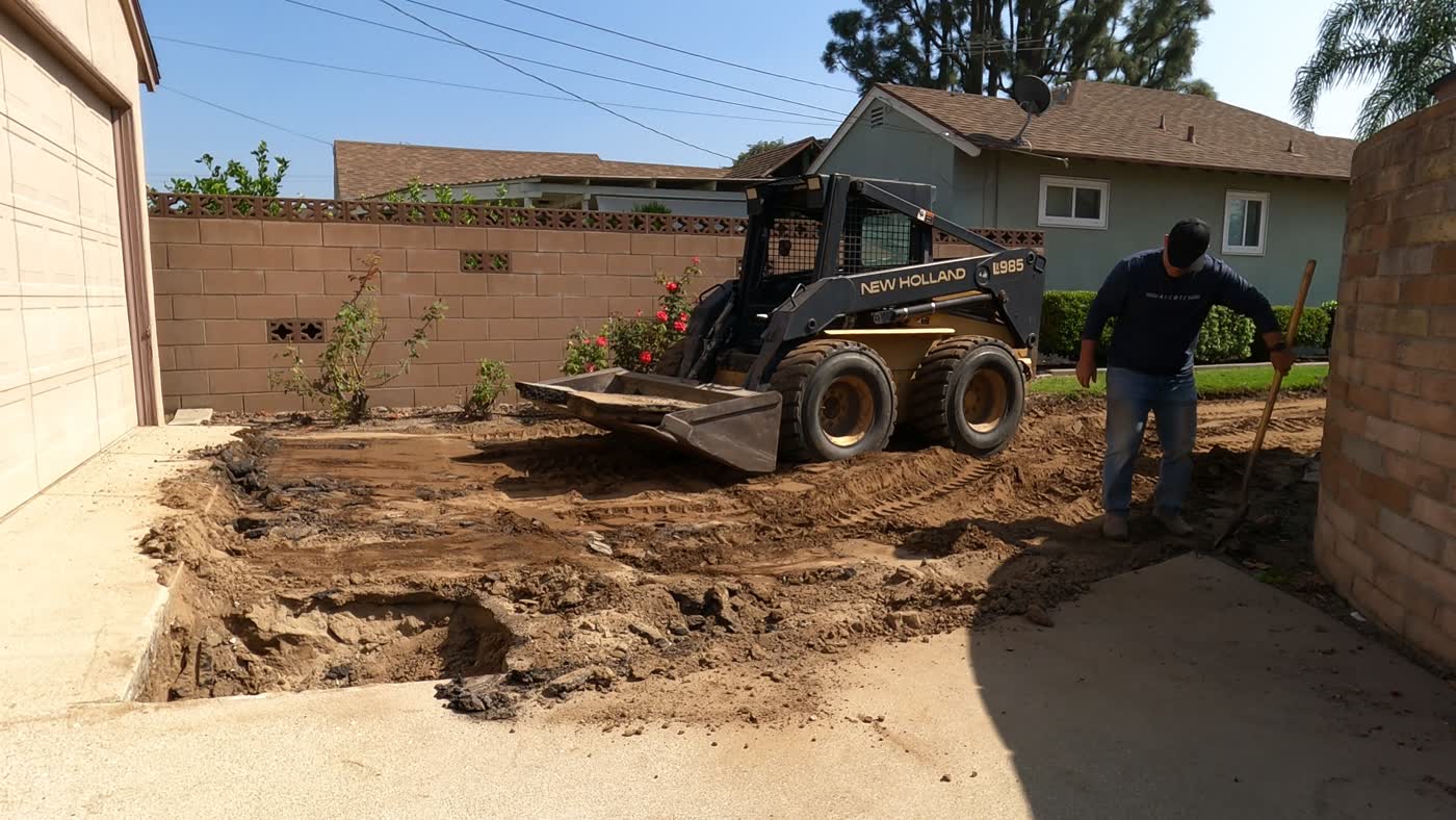 Grading the driveway area with a skid steer