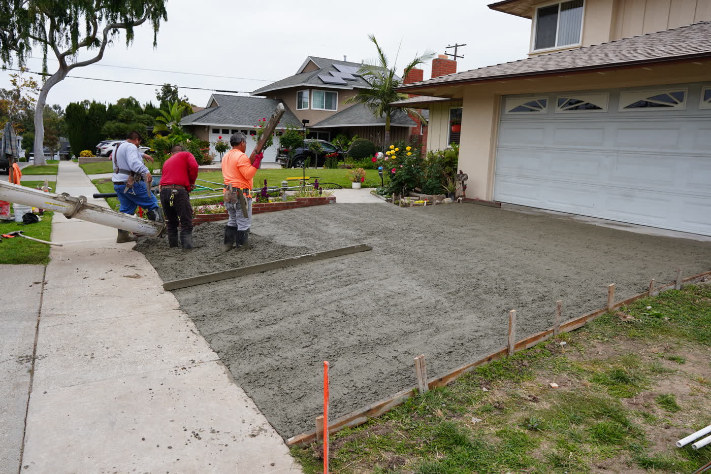 Crew spreading and screeding the fresh concrete