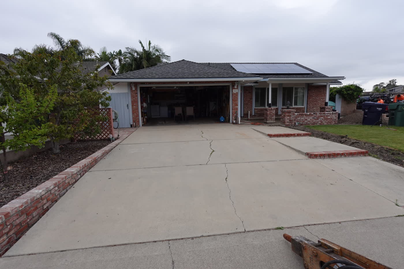 Cracked two-car concrete driveway before replacement in Huntington Beach