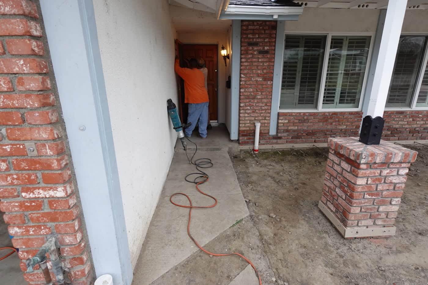 Breaking out the old front entry slab by the brick columns