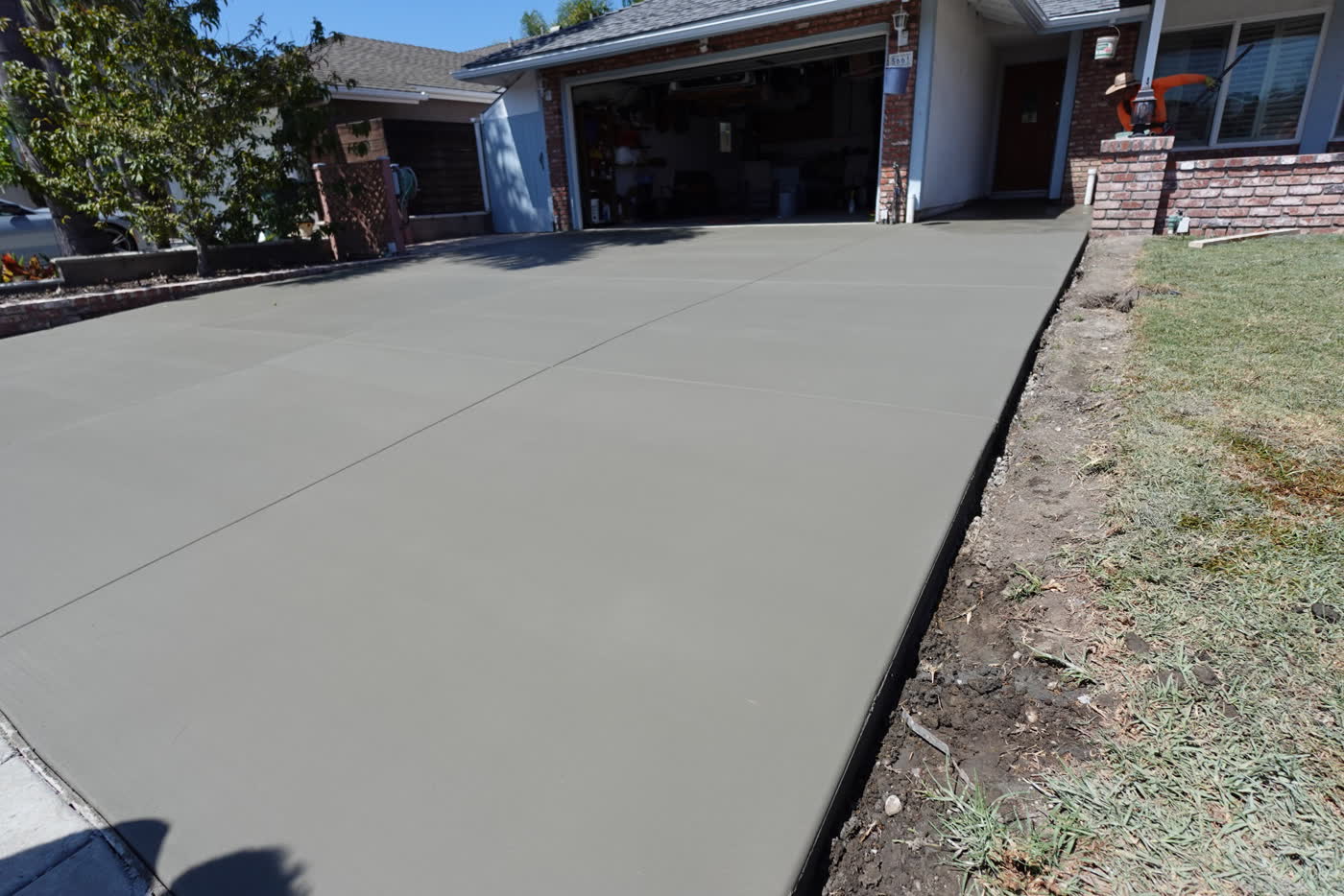 New broom-finish concrete driveway at a Huntington Beach home