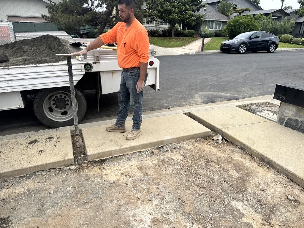 Driveway Masters crew member at a project site with the work truck