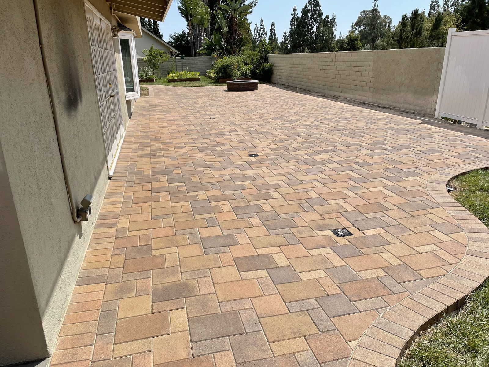 Light tan paver patio along a house